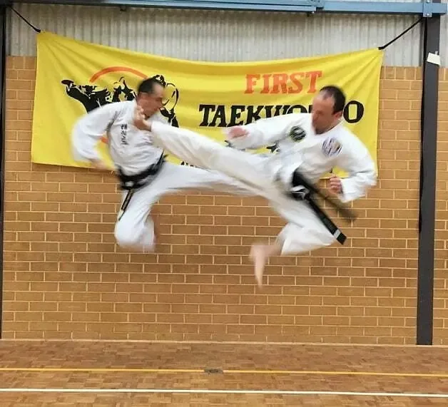 Kensington Taekwondo Instructor and Assistant Instructor performing jumping kicks